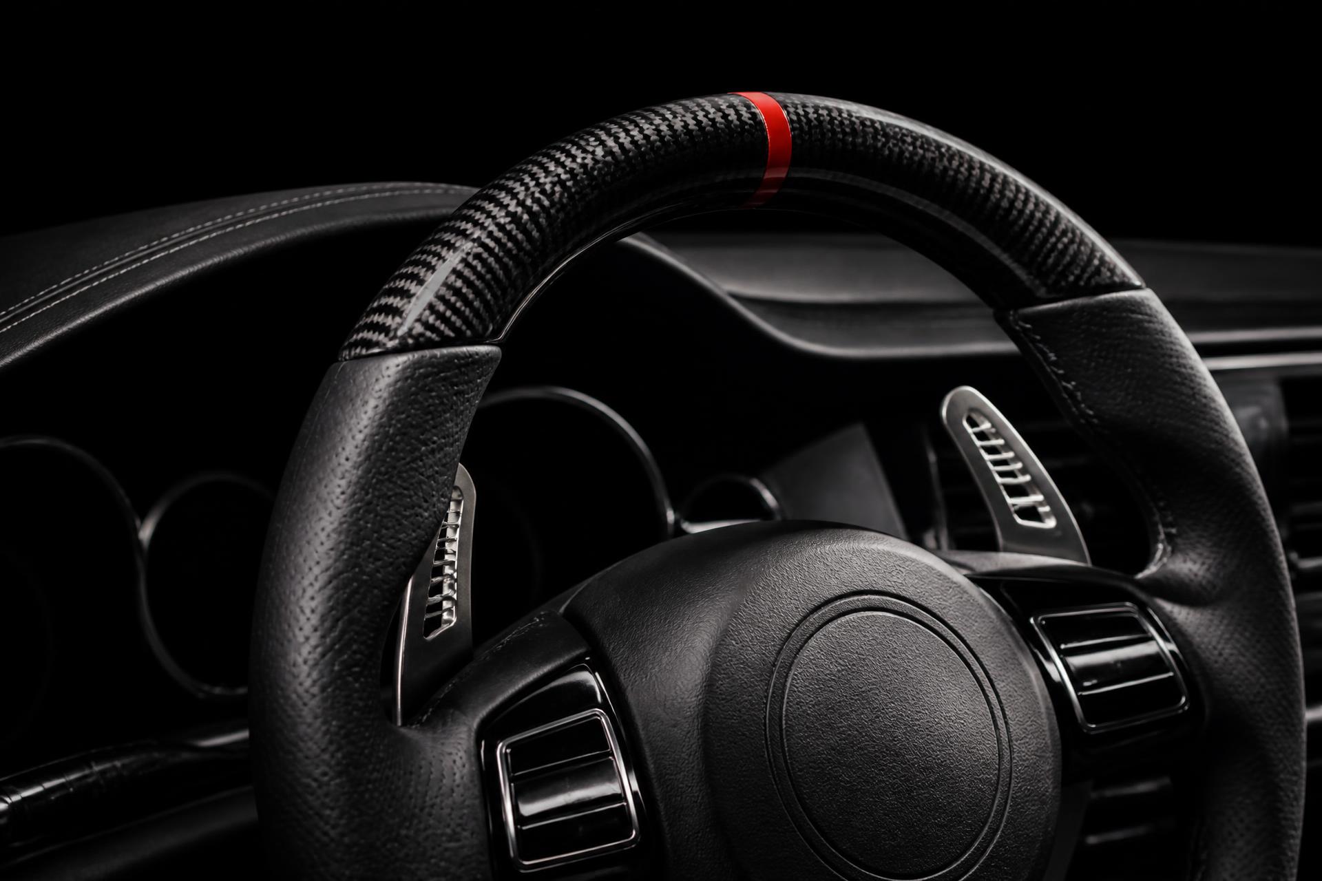 Premium aftermarket BMW steering wheel in a dark interior